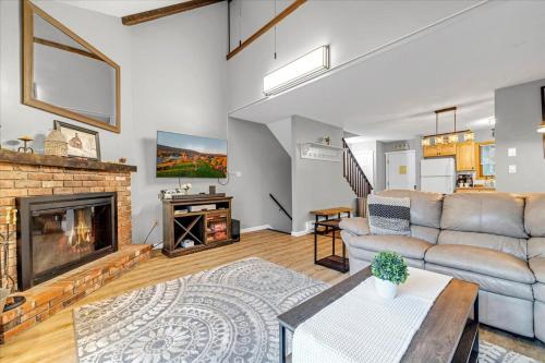 a living room with a couch and a fireplace at C52-CAMELBACK waterPark,Pool,Tennis,Zipline,hottub in Tannersville