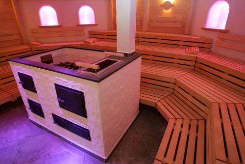 an inside view of a church with wooden pews at Hotel Thermana Park Laško**** Superior in Laško