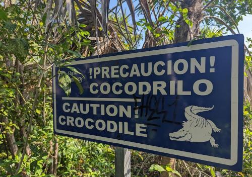 a blue sign for a crocodile evacuationcolo at Beachfront Breathtaking Views Puerto Aventuras in Puerto Aventuras