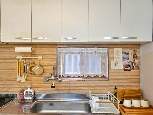 a kitchen with a sink and a window at Ro-un house in Seoul