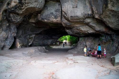 a group of people standing in front of a cave at Ferienapartment "An der Forellenschänke" in Sebnitz
