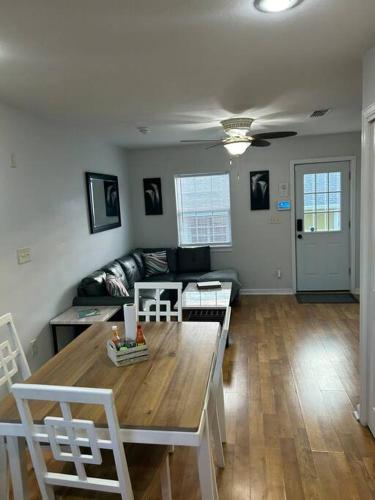 a living room with a table and a couch at Bay Breeze Bliss-Hot Tub, Bar and Canal 5mi to Beach in Shoreline Park
