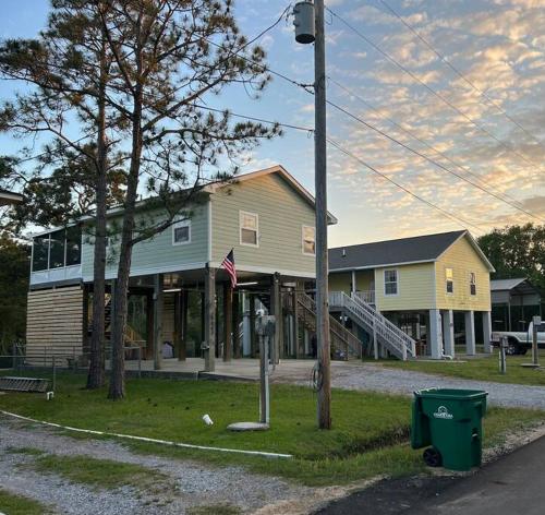 a house on a street in front of a building at Bay Breeze Bliss-Hot Tub, Bar and Canal 5mi to Beach in Shoreline Park