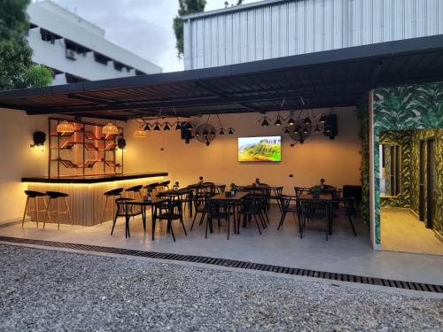 a dining area with tables and a bar in a building at Solmi Rooms in Calero