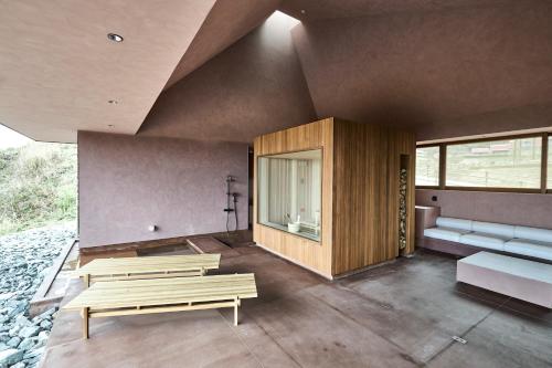a room with two benches and a room with windows at Snow Peak YAKEI SUITE ABURAYAMA FUKUOKA in Fukuoka
