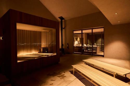 a room with two benches and a large window at Snow Peak YAKEI SUITE ABURAYAMA FUKUOKA in Fukuoka
