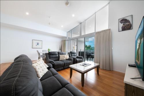 a living room with a couch and a table at Azure Sea Whitsunday Resort in Airlie Beach