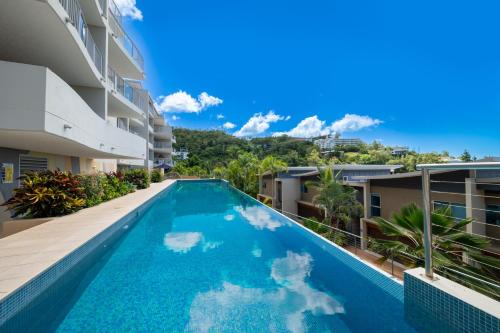 a swimming pool in the middle of a building at Azure Sea Whitsunday Resort in Airlie Beach