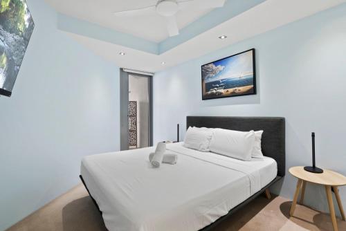 a bedroom with a large white bed and a table at Experience Brisbane in Style Spacious 3 BR Retreat with Parking in West End in Brisbane