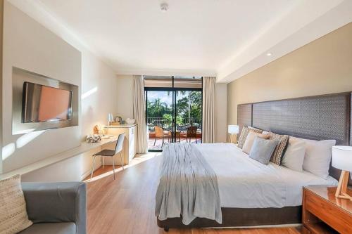 A bed or beds in a room at Harbourfront Resort - King Studio with Balcony & Pool