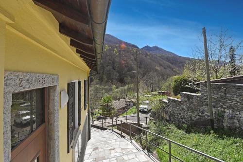 a building with a balcony with a view of a mountain at Casa Lara - Happy Rentals in Lugano