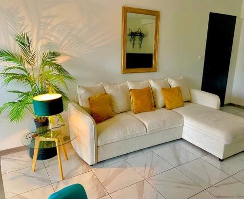 a white couch with orange pillows in a living room at Toulouse in Toulouse