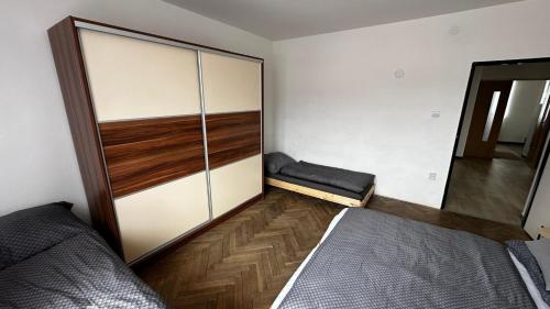a bedroom with a bed and a closet at DáMa in Ružomberok