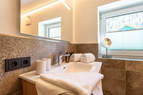 a bathroom with a sink and a mirror at Maurig Appartements in Elbigenalp