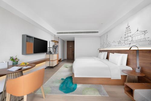 TV a/nebo společenská místnost v ubytování 西安高新六路万象汇逸扉酒店 UrCove by Hyatt Xi 'an Gaoxin Wanxianghui Hotel