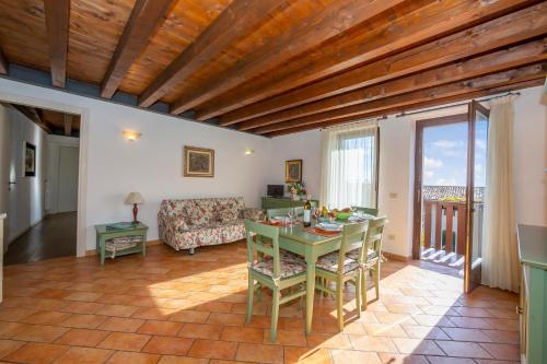 a living room with a table and a couch at Orchidea in Hilly area - Happy Rentals in Gargnano