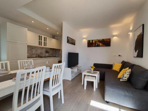 a living room and kitchen with a couch and a table at Apartments Vodaric in Cres