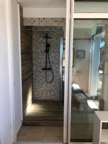 una doccia con una croce sul muro in bagno di Manapany ti coin charmant a Saint-Joseph
