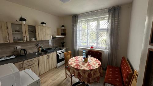 a kitchen with a table and a kitchen with a window at DáMa in Ružomberok