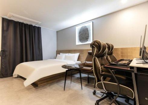 una camera con letto e scrivania con computer di Carlton Hotel Bupyeong a Incheon