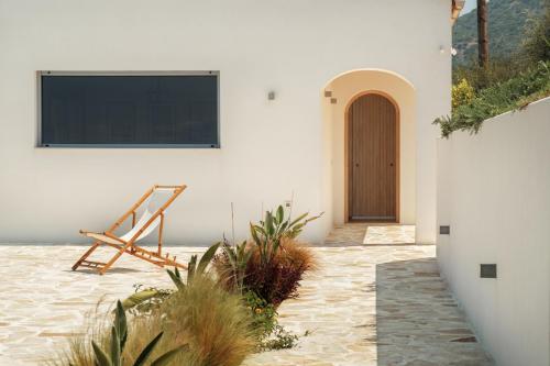 a building with a television and a chair in a courtyard at Villa Thea in Mochlos