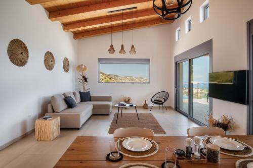 a living room with a couch and a table at Villa Thea in Mochlos