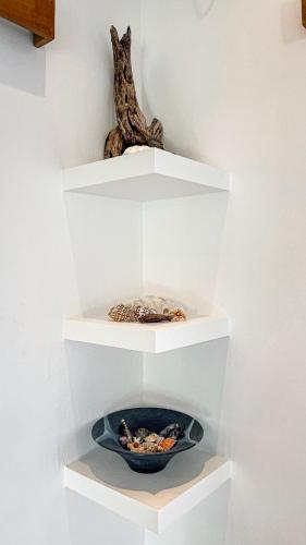 a white shelf with a bowl of food in it at Green Valley Lombok in Selong Belanak