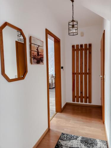 a living room with a mirror and a door at Ferienhaus Ebern-Sölln in Ebern