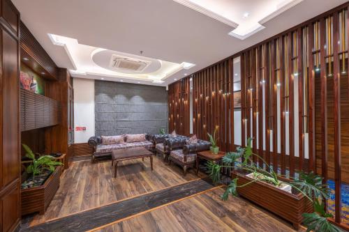 a living room with couches and plants at WelcomHeritage Elysium Resort & Spa in Shimla