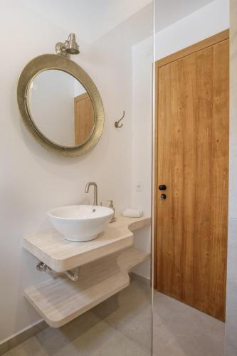 a bathroom with a sink and a mirror at Villa Thea in Mochlos