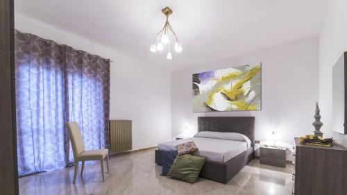 a bedroom with a bed and a table and a chair at Appartamento Stapane by Palazzo Stapane in Galatone