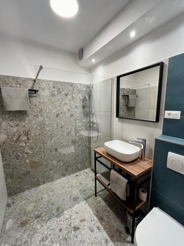 a bathroom with a sink and a shower at Marija Big & Comfortable in Baška