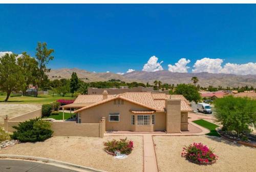 a house in a subdivision with mountains in the background at Spacious house with pool at Mission Lake in Desert Hot Springs