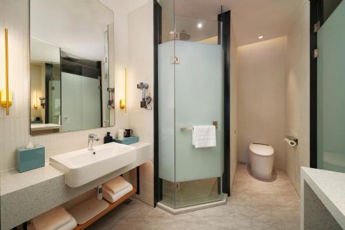a bathroom with a sink and a toilet at SSAW Boutique Hotel Hangzhou Chengjun in Hangzhou