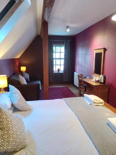 a hotel room with a large bed and a living room at Lime Tree Hotel in Fort William