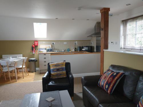a living room with a couch and a table and a kitchen at Lime Tree Hotel in Fort William