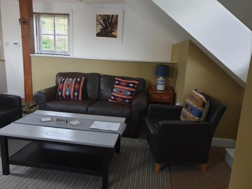a living room with a couch and two chairs at Lime Tree Hotel in Fort William