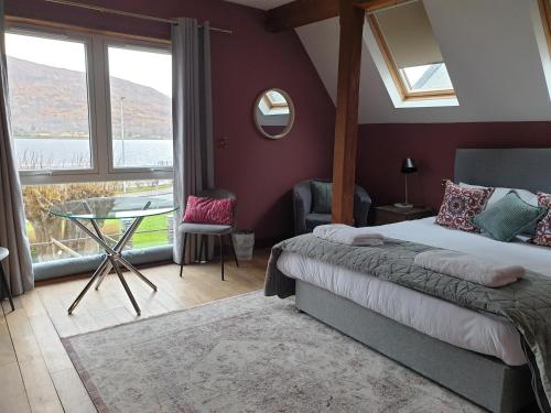 a bedroom with a bed and a table and a window at Lime Tree Hotel in Fort William