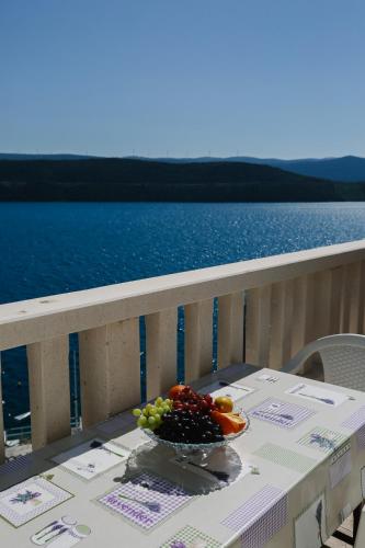 a bowl of fruit sitting on a table on a balcony at Villa Lasić Neum in Neum