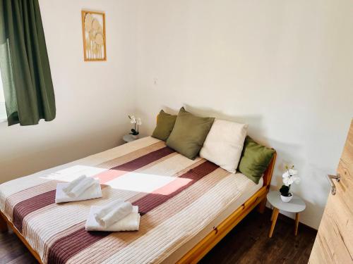 a bedroom with a bed with two pillows on it at Frankenberg Ferienwohnung in Aschbach