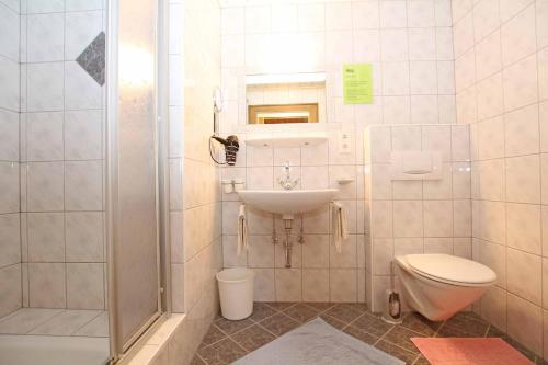 a bathroom with a sink and a toilet and a shower at Pension Delacher in Ried im Oberinntal