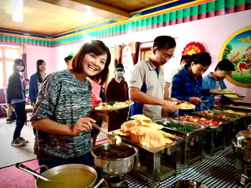 a group of people preparing food in a buffet at Hotel Pangong Residency in Leh