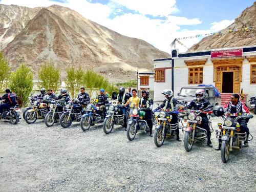 a group of people on motorcycles parked in front of a building at Hotel Pangong Residency in Leh