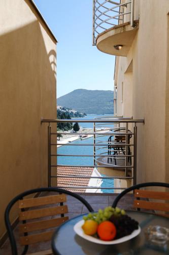 a plate of fruit on a table on a balcony at Villa Lasić Neum in Neum