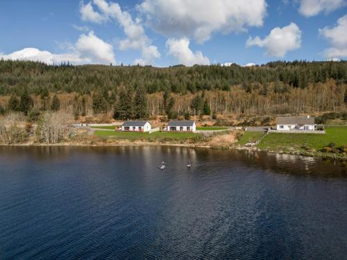 an aerial view of a lake with houses and buildings at Loch Ness Cottage in Fort Augustus