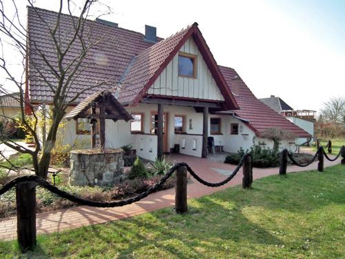 a house with a fence in front of it at Haus Jasmin in Bodstedt