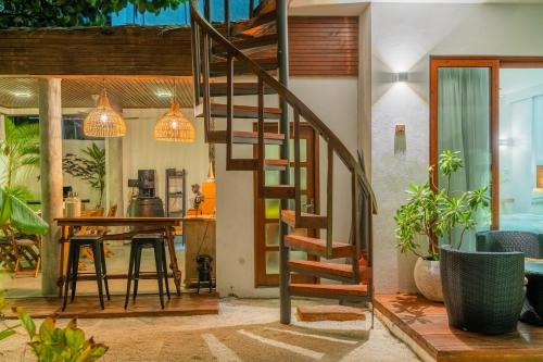 a spiral staircase in a living room with a table at Veli Vilaa in Dhiffushi