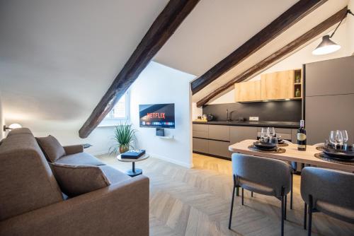 a living room with a couch and a table at Turin Sky House City Center in Turin