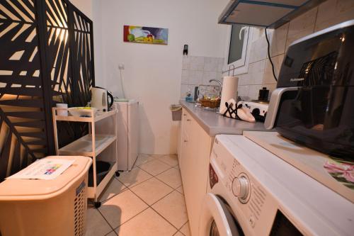 a kitchen with a washer and dryer in it at Unique studio at Athens Riviera 1 min from the sea in Athens