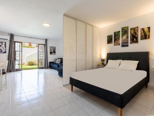 a bedroom with a bed and a living room at Port Royale 291, Spacious Studio in Los Cristianos